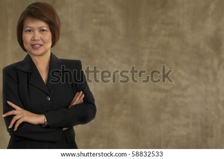 Portrait of middle aged Asian woman with her arms crossed