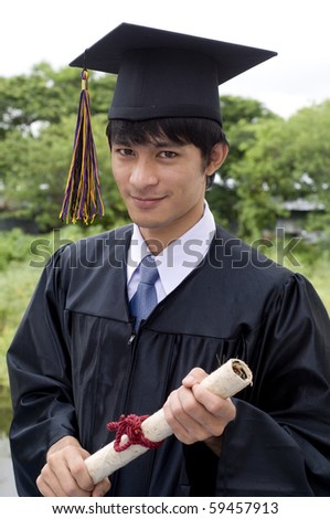 Young man with graduation cap and gown and diploma