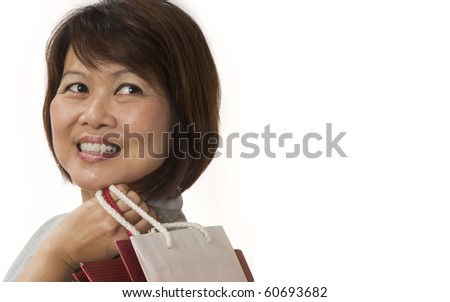 stock photo Mature Asian woman with shopping bags isolated on white
