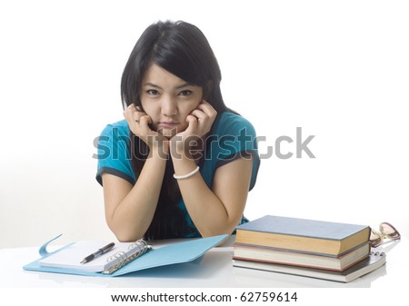 Young attractive female Asian student holding her school books