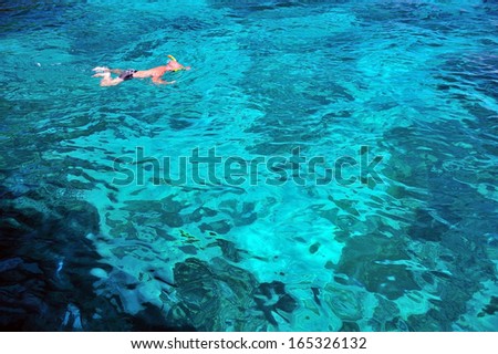 sporting man swims in the sea