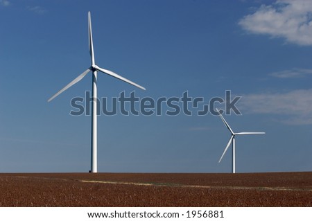Two windmills in a soybean field