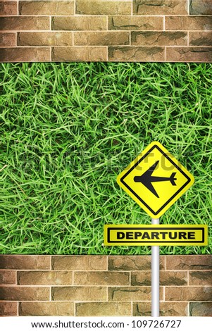Airplane departure sign on Grunge brick wall green grass background