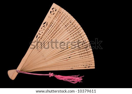 Partially opened bamboo fan with pink tassel, black iso.