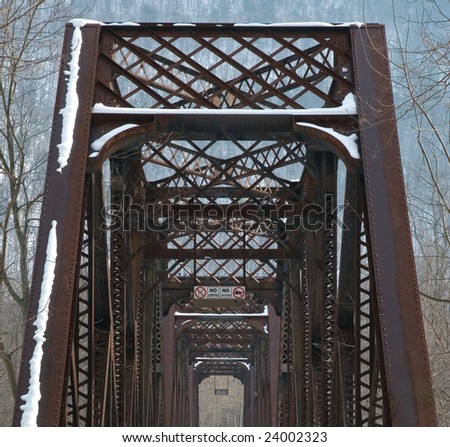 View of old, rusty railroad bridge converted to hiking and biking trail for recreation.