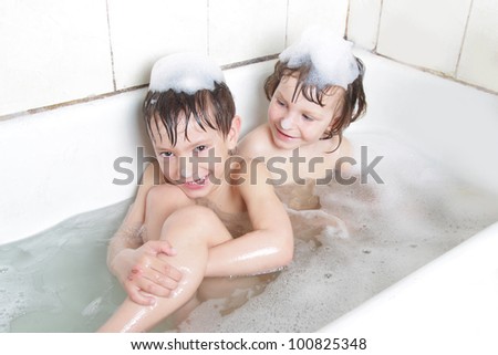 two children having bath
