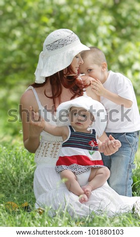 mother and two children on natural background