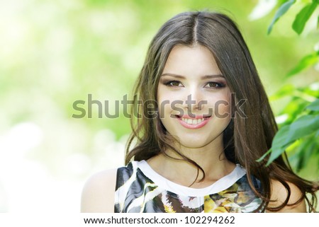 Summer girl portrait. Young woman smiling happy on sunny summer or spring day outside in park. young woman outdoors.