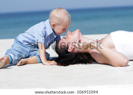 outdoor portrait of young happy mother and child on natural background