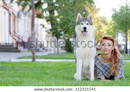 young happy woman and haski dog outdoors on natural background