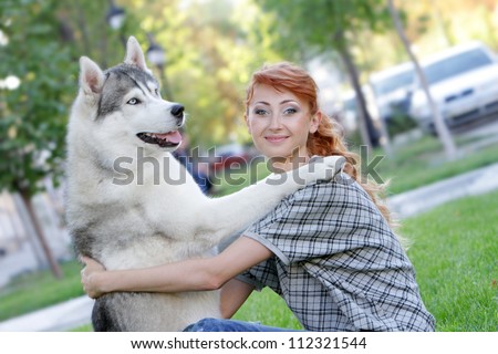 young happy woman and haski dog outdoors on natural background