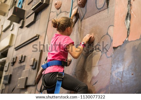 kid, child having fun on a climbing wall in an indoor climbing center, active healthy lifestyle, active children in sports