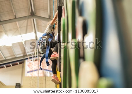 kid, child having fun on a climbing wall in an indoor climbing center, active healthy lifestyle, active children in sports