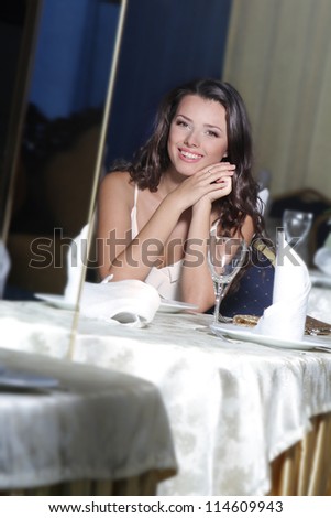 portrait of young happy beautiful woman in restaurant