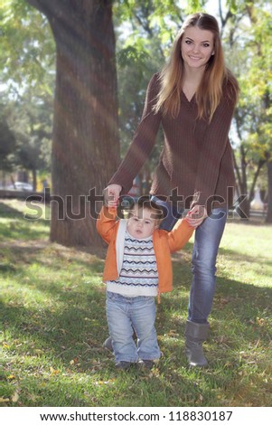 young happy mother with baby child on natural background
