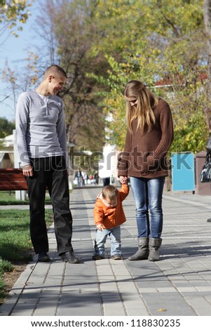 young happy family with baby child on natural background background