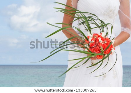 beautiful bride holding bridal bouquet on natural background