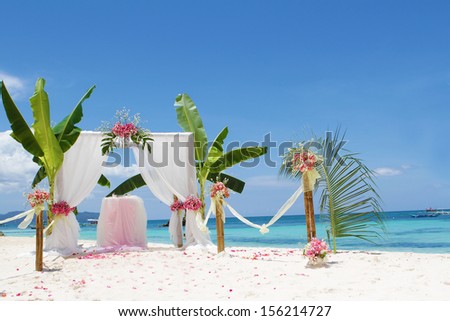 wedding arch - tent - decorated with flowers on beach, tropical wedding ceremony set up