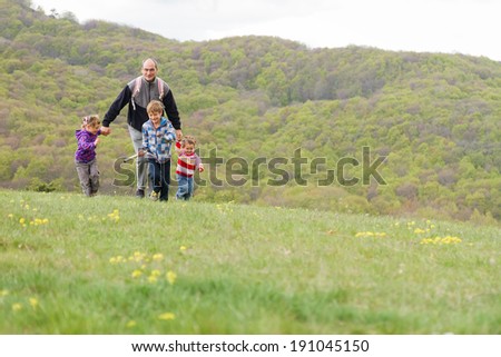 happy family with three kids enjoying free time on natural background
