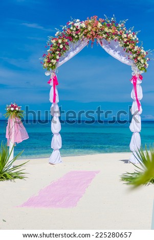 wedding arch, cabana, gazebo on tropical beach decorated with flowers, beach wedding decoration