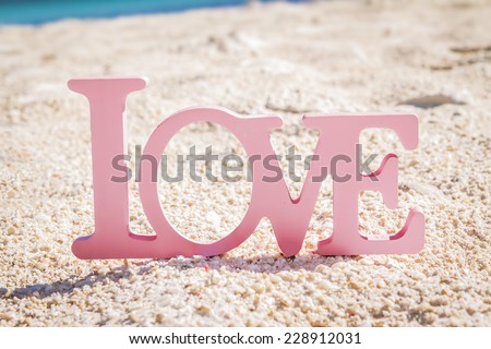 love word on natural tropical background, beach wedding concept