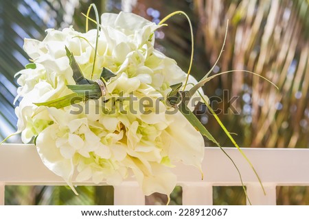 traditional philippino palm tree birds with wedding rings on wedding bouquet background
