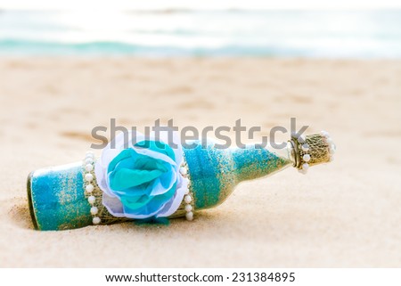glass bottle with colored sand on natural background, sand ceremony, beach wedding