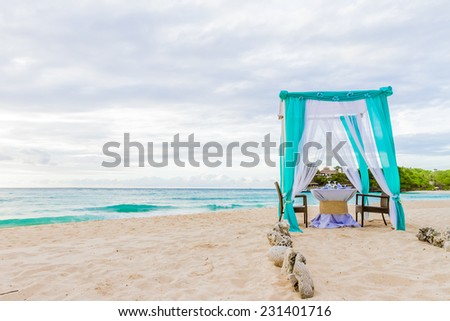wedding arch and set up on beach, tropical outdoor wedding cabana on beach, wedding table for dinner at sunset