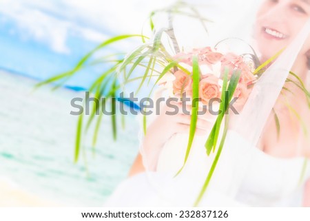 young beautiful bride on the wedding day with wedding bouquet on tropical sea and beach background