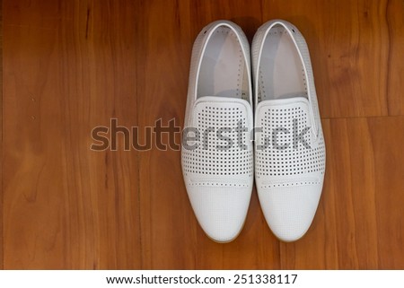 Male dress shoes, elegant wedding groom boots called derby shoes, leather white cloth empty shoes in horizontal orientation, nobody