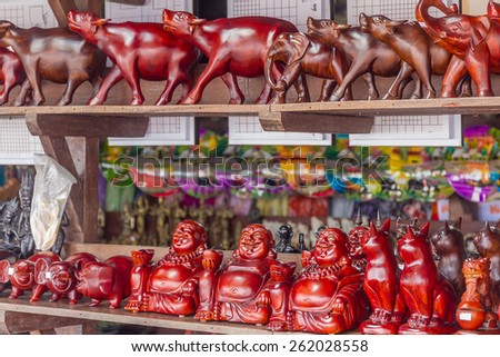 wooden crafted figurines in a souvenir shop, cambodia, siem reap