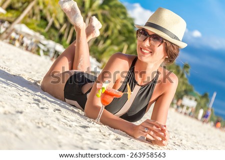 young happy beautiful woman enjoying summer vacation on tropical sand beach, sunbathing, outdoor portrait