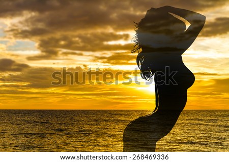 beautiful female silhouette on sunset sea background