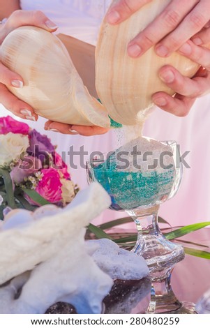 young loving couple, bride and groom, on their wedding day on wedding setup, arch, venue background, sand ceremony