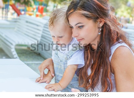 mother and child - baby boy - enjoying meal time in street cafe, restaurant, family time, lunch in outdoor restaurant