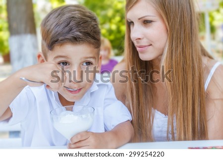 mother and child - boy - enjoying meal time in street cafe, restaurant, family time, lunch in outdoor restaurant
