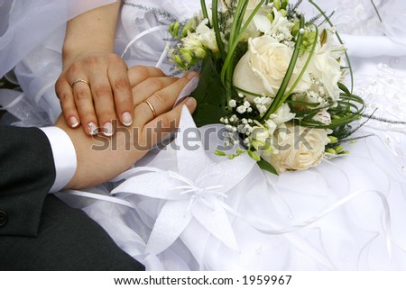 Just married - hands, rings, bouquet