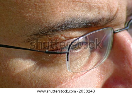 close up of eye and glasses, focus on eye