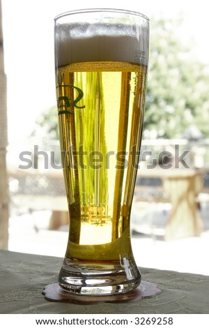 glass of beer on street cafe terrace background