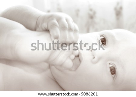 baby with his foot in mouth