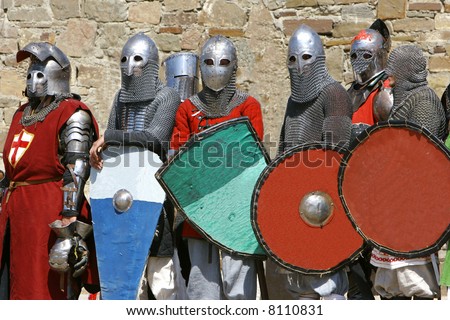 stock-photo-several-knights-on-stone-wall-background-8110831.jpg