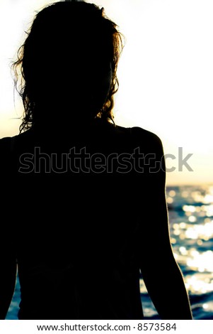 female silhouette on blurred sea background