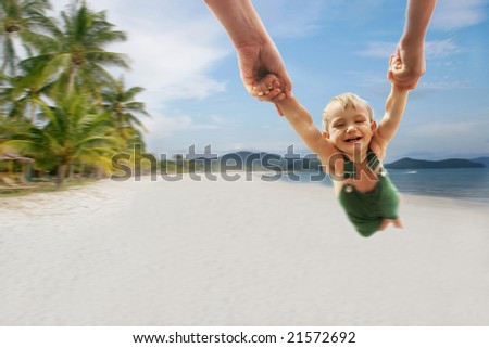 flying boy on sand beach background