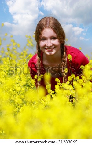 happy young girl in yellow flowers