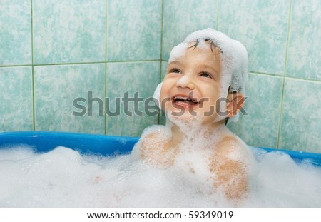 happy child in soap foam