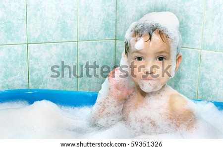 cute child in soap foam
