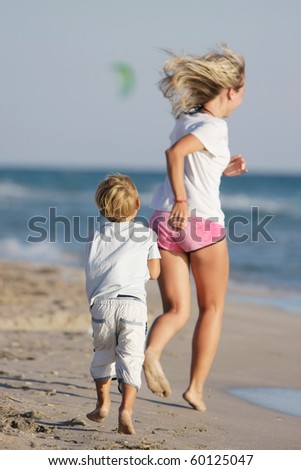 mother and son running on beach