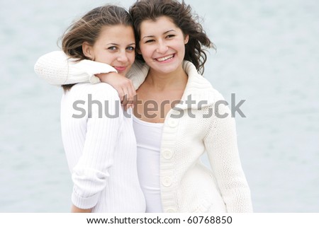 two young happy girls on natural background