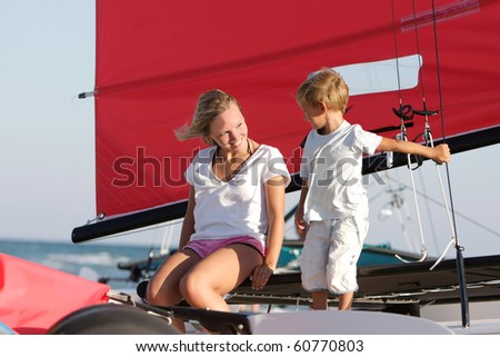 happy mother and son on sea yacht background