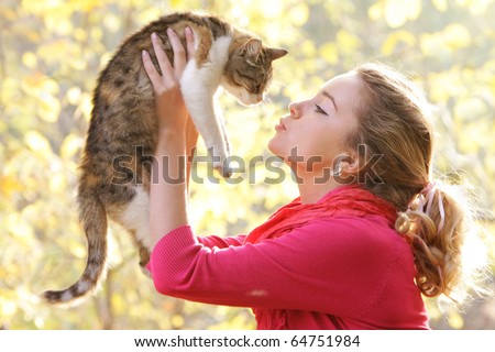young attractive girl with cat on natural background
